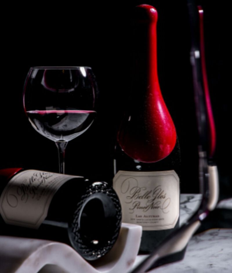 Bottles of Belle Glos 'Los Alturas Vineyard' Santa Lucia Highlands Pinot Noir with a wine glass