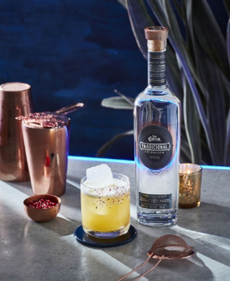 A bottle of Jose Cuervo® Tequila Tradicional Cristalino with a cocktail and cocktail making tools