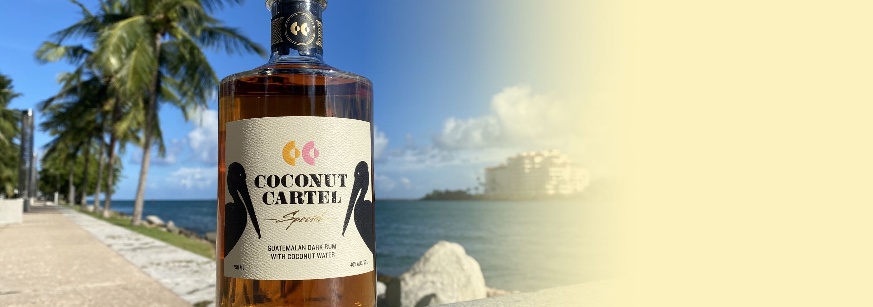A bottle of Coconut Cartel Rum at the beach